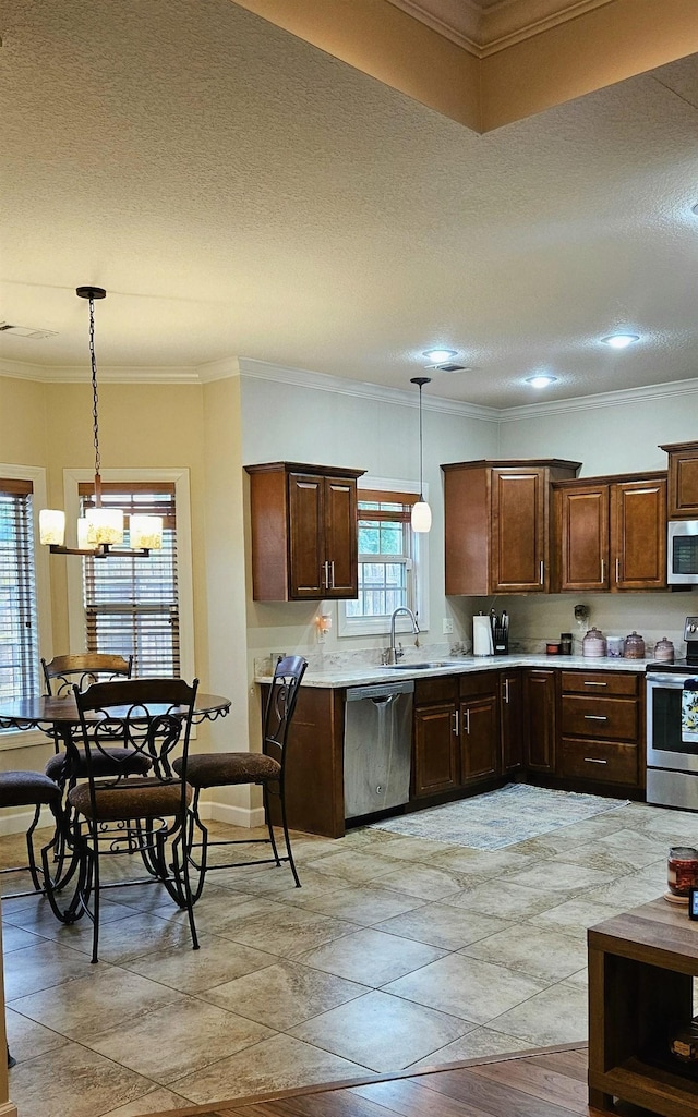 795 S Hill Dr, Jonesboro, AR 72401 - kitchen featuring appliances with stainless steel finishes, light countertops, a chandelier, a textured ceiling, and pendant lighting