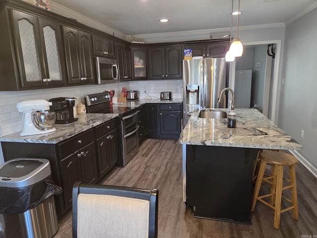 1209 Rehoboth, Searcy, AR 72143 - kitchen with appliances with stainless steel finishes, tasteful backsplash, glass insert cabinets, crown molding, and a center island with sink
