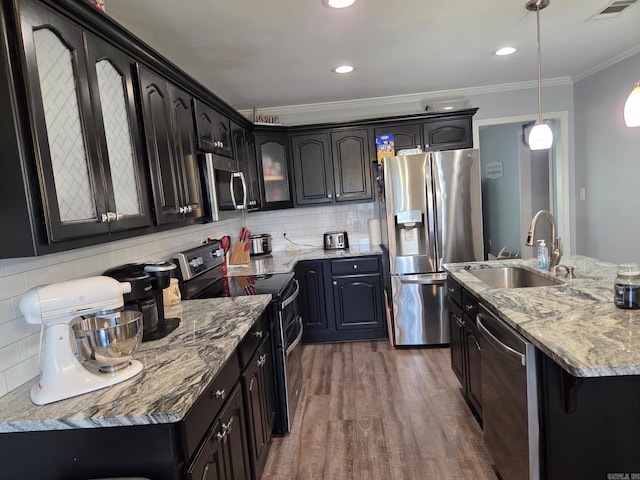 1209 Rehoboth, Searcy, AR 72143 - kitchen with appliances with stainless steel finishes, ornamental molding, dark wood-type flooring, backsplash, and glass insert cabinets