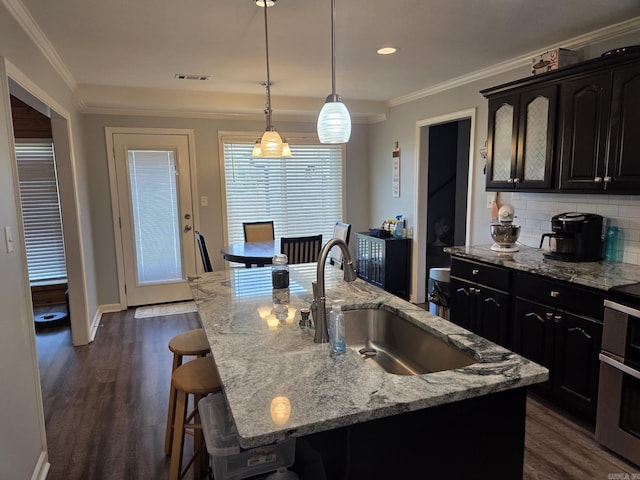 1209 Rehoboth, Searcy, AR 72143 - kitchen featuring a breakfast bar, double oven range, tasteful backsplash, ornamental molding, and dark wood-style floors