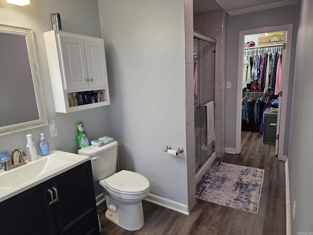 1209 Rehoboth, Searcy, AR 72143 - full bathroom with wood finished floors, vanity, a shower stall, a walk in closet, and ornamental molding
