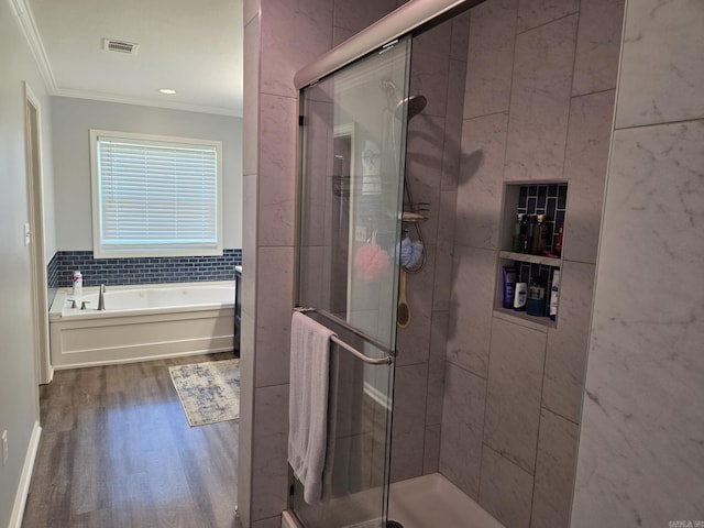 1209 Rehoboth, Searcy, AR 72143 - full bathroom featuring ornamental molding, a garden tub, wood finished floors, a stall shower, and tile walls