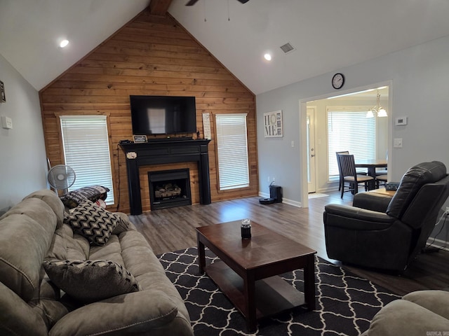 1209 Rehoboth, Searcy, AR 72143 - living area with a ceiling fan, wooden walls, a fireplace, wood finished floors, and high vaulted ceiling