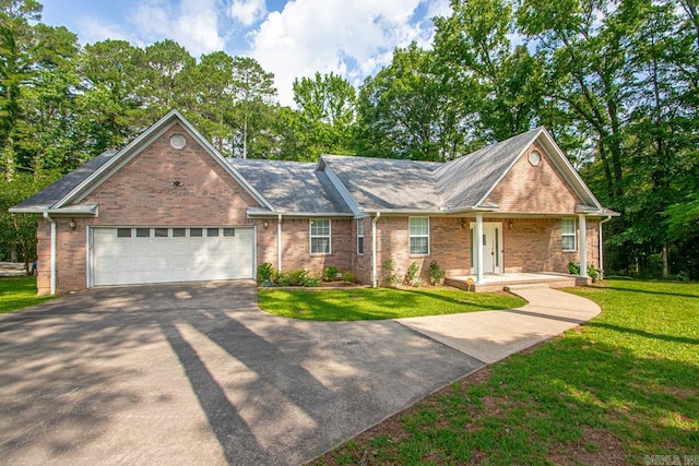 1226 Grayson Cir, Malvern, AR 72104 - view of front of house featuring asphalt driveway, a front lawn, an attached garage, and brick siding