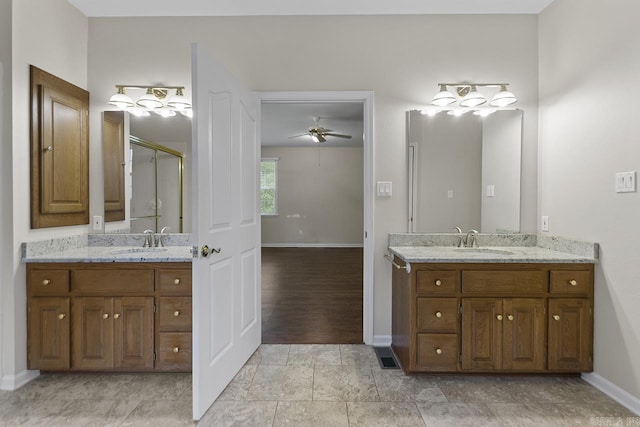 1226 Grayson Cir, Malvern, AR 72104 - bathroom with a shower stall, vanity, and ceiling fan