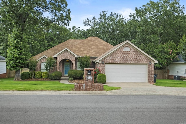 5132 Austin Lakes Cir, Sherwood, AR 72120 - view of front of house with brick siding, a garage, driveway, and a front yard