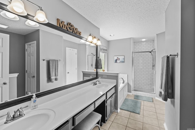 5132 Austin Lakes Cir, Sherwood, AR 72120 - bathroom featuring a textured ceiling, a bath, double vanity, a stall shower, and tile patterned flooring