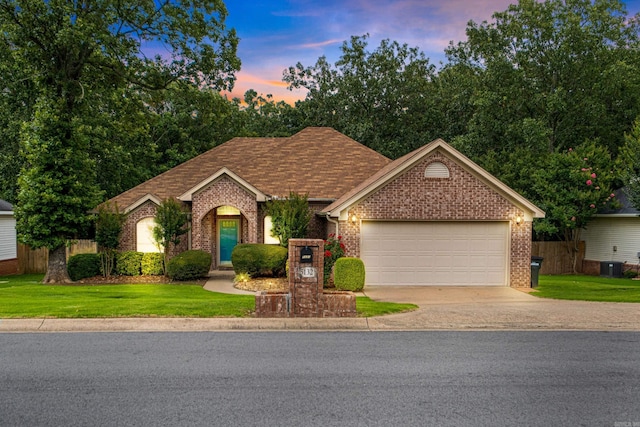 5132 Austin Lakes Cir, Sherwood, AR 72120 - view of front of property with brick siding, an attached garage, concrete driveway, and a front yard