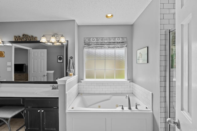 5132 Austin Lakes Cir, Sherwood, AR 72120 - full bathroom featuring a tub with jets, vanity, a textured ceiling, and tiled shower