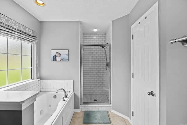 5132 Austin Lakes Cir, Sherwood, AR 72120 - full bathroom featuring a tub with jets, a shower stall, a textured ceiling, and tile patterned flooring
