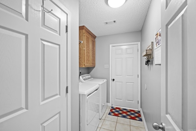 5132 Austin Lakes Cir, Sherwood, AR 72120 - washroom with washer and clothes dryer, cabinet space, light tile patterned floors, and a textured ceiling