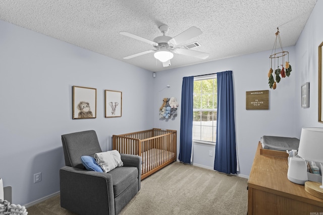 5132 Austin Lakes Cir, Sherwood, AR 72120 - carpeted bedroom featuring a nursery area, a ceiling fan, and a textured ceiling