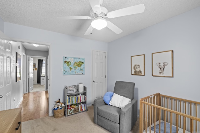 5132 Austin Lakes Cir, Sherwood, AR 72120 - bedroom with a textured ceiling, ceiling fan, and light wood-type flooring