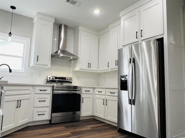 112 S Eagle, Sheridan, AR 72150 - kitchen featuring appliances with stainless steel finishes, wall chimney range hood, white cabinets, dark wood-type flooring, and recessed lighting