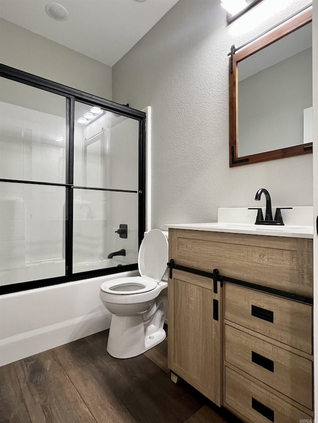 112 S Eagle, Sheridan, AR 72150 - full bathroom with wood finished floors, a textured wall, vanity, and combined bath / shower with glass door