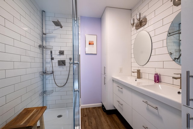 2908 Breckenridge Dr, Little Rock, AR 72227 - full bathroom featuring a stall shower, double vanity, and wood finished floors