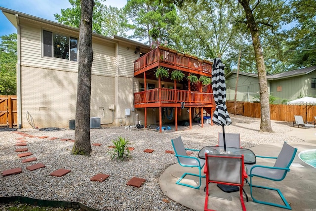 2908 Breckenridge Dr, Little Rock, AR 72227 - rear view of house featuring a fenced backyard, a deck, a patio area, and brick siding