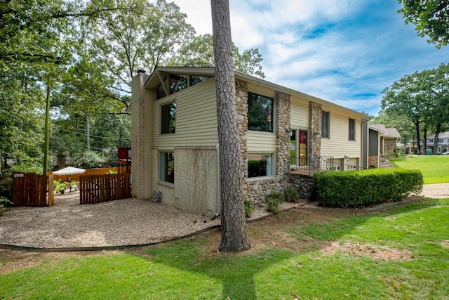 2908 Breckenridge Dr, Little Rock, AR 72227 - rear view of property featuring stone siding and a chimney