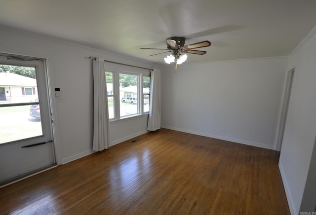 spare room with a ceiling fan, wood finished floors, and crown molding