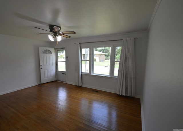 empty room featuring wood finished floors, ceiling fan, and ornamental molding