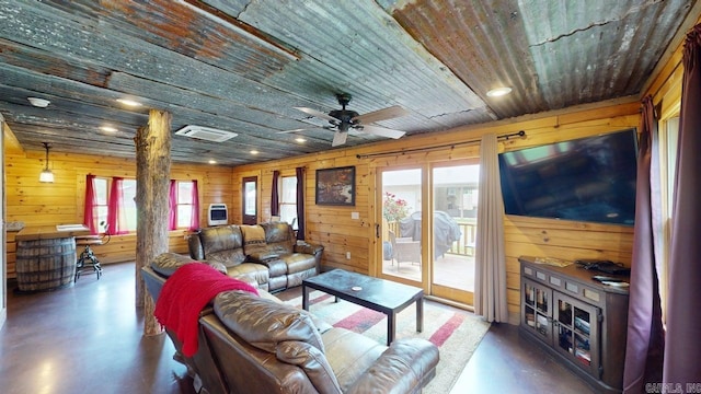 25 Jared Cir, Heber Springs, AR 72543 - living room with healthy amount of natural light, wooden walls, wood ceiling, concrete floors, and a ceiling fan