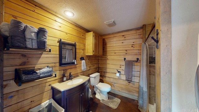 25 Jared Cir, Heber Springs, AR 72543 - bathroom featuring wooden walls, a textured ceiling, vanity, and concrete floors