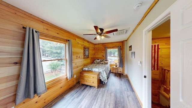 25 Jared Cir, Heber Springs, AR 72543 - bedroom featuring wood finished floors, wooden walls, and a ceiling fan