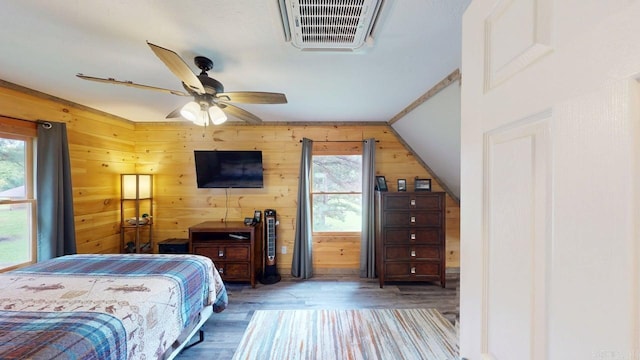 25 Jared Cir, Heber Springs, AR 72543 - bedroom with multiple windows, wood finished floors, wooden walls, and ceiling fan