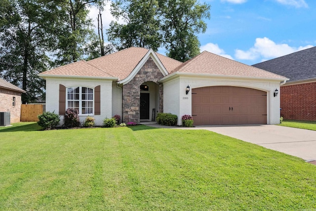 2355 Wilmington, Conway, AR 72034 - view of front of house featuring an attached garage, driveway, stone siding, and roof with shingles