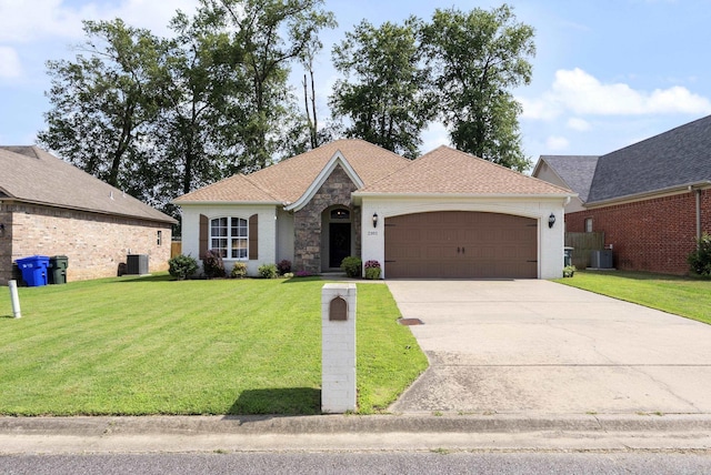 2355 Wilmington, Conway, AR 72034 - view of front of home featuring a garage, a front yard, driveway, and stone siding