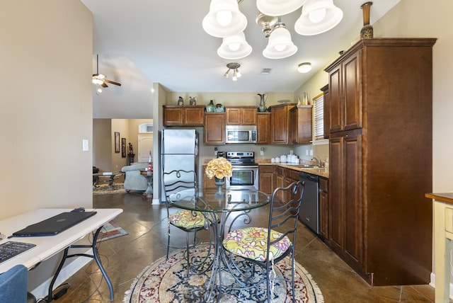 2355 Wilmington, Conway, AR 72034 - kitchen with stainless steel appliances, ceiling fan, light countertops, a chandelier, and brown cabinetry