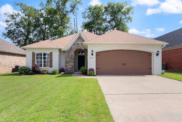 2355 Wilmington, Conway, AR 72034 - view of front of property with an attached garage, concrete driveway, stone siding, a front lawn, and roof with shingles