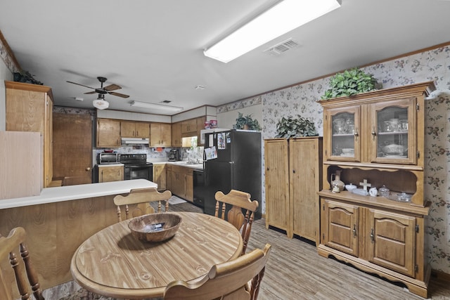 309 N Seaman St, Mccrory, AR 72101 - dining space with wallpapered walls, light wood-style floors, and a ceiling fan