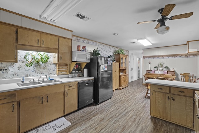 309 N Seaman St, Mccrory, AR 72101 - kitchen featuring black appliances, wallpapered walls, light countertops, wood finished floors, and a ceiling fan