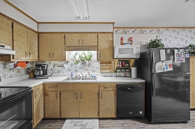 309 N Seaman St, Mccrory, AR 72101 - kitchen featuring black appliances, light countertops, under cabinet range hood, light wood-type flooring, and wallpapered walls