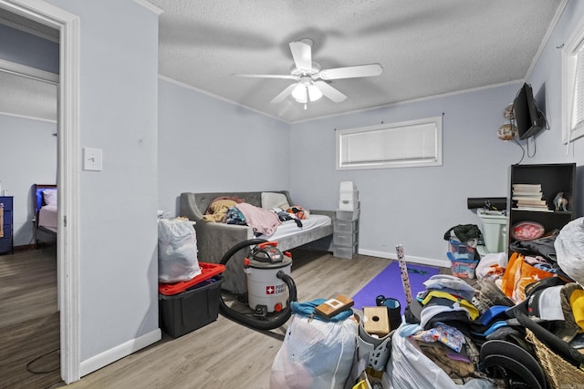309 N Seaman St, Mccrory, AR 72101 - bedroom featuring wood finished floors, crown molding, a textured ceiling, and ceiling fan