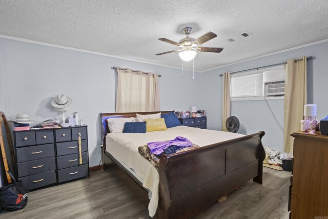 309 N Seaman St, Mccrory, AR 72101 - bedroom featuring wood finished floors, crown molding, a textured ceiling, and a ceiling fan