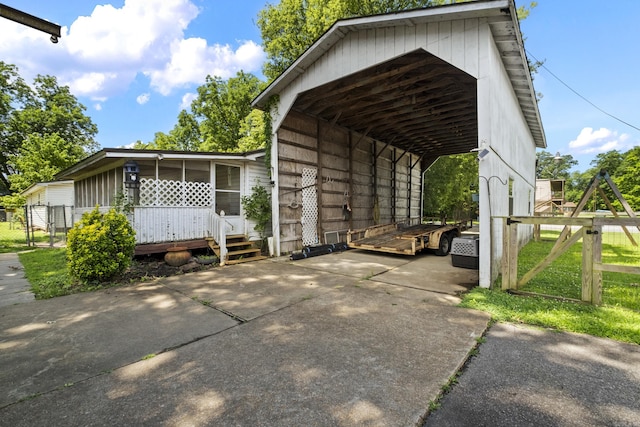 309 N Seaman St, Mccrory, AR 72101 - view of parking featuring a detached carport, concrete driveway, and a gate