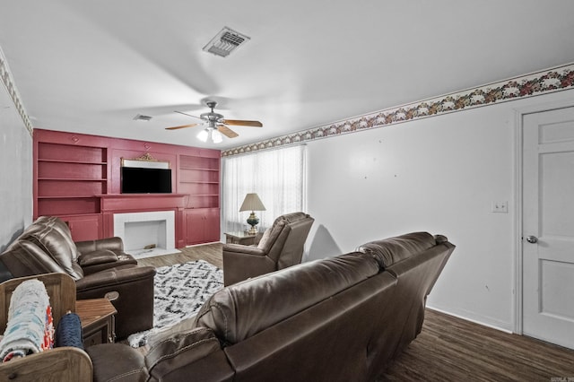 309 N Seaman St, Mccrory, AR 72101 - living room with ceiling fan, wood finished floors, built in shelves, and a fireplace with flush hearth