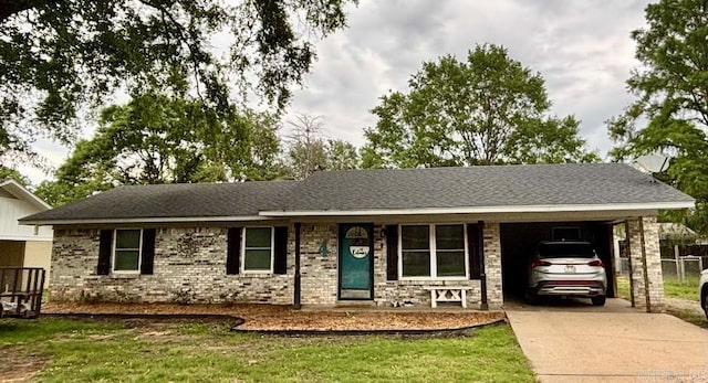 4 Paul St, Mcgehee, AR 71654 - ranch-style house featuring concrete driveway, an attached carport, a front lawn, and a shingled roof