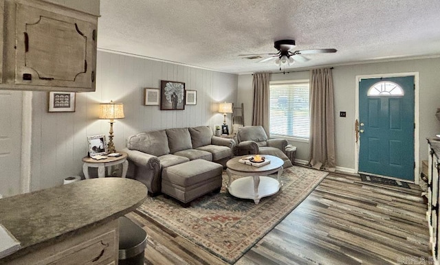 4 Paul St, Mcgehee, AR 71654 - living room featuring ceiling fan, a textured ceiling, wood finished floors, and ornamental molding
