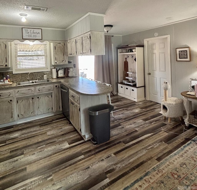 4 Paul St, Mcgehee, AR 71654 - kitchen with dark wood finished floors, dishwasher, a peninsula, crown molding, and a textured ceiling