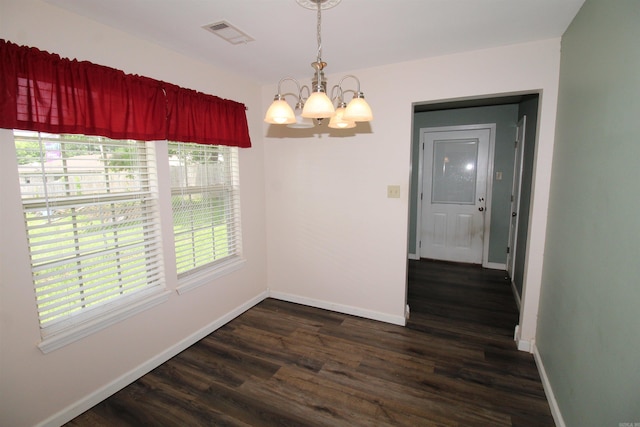 206 E Gum St, Sheridan, AR 72150 - unfurnished dining area featuring a chandelier and dark wood-type flooring