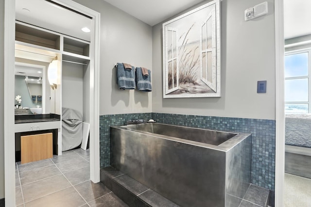 521 President Clinton Ave Unit 1101, Little Rock, AR 72201 - full bath featuring tile walls, tile patterned floors, a tub, a wainscoted wall, and vanity