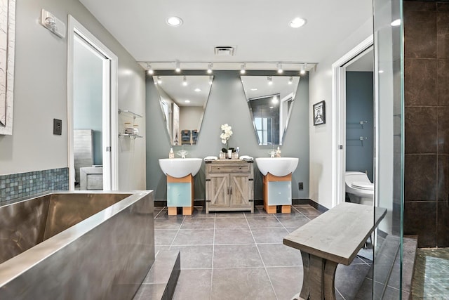 521 President Clinton Ave Unit 1101, Little Rock, AR 72201 - bathroom featuring track lighting, tile patterned flooring, vanity, a tub to relax in, and recessed lighting
