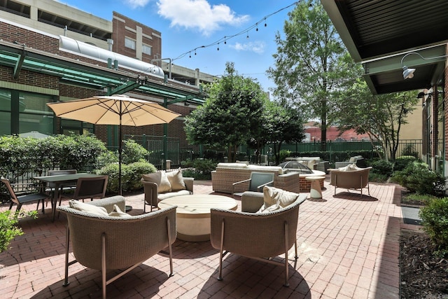 521 President Clinton Ave Unit 1101, Little Rock, AR 72201 - view of patio with outdoor dining space and an outdoor living space with a fire pit