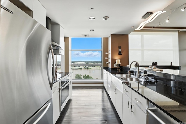 521 President Clinton Ave Unit 1101, Little Rock, AR 72201 - kitchen featuring stainless steel appliances, white cabinetry, modern cabinets, a water view, and dark stone countertops