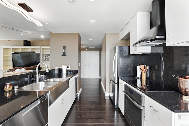521 President Clinton Ave Unit 1101, Little Rock, AR 72201 - kitchen featuring wall chimney exhaust hood, stainless steel appliances, dark wood-style flooring, white cabinetry, and dark stone counters