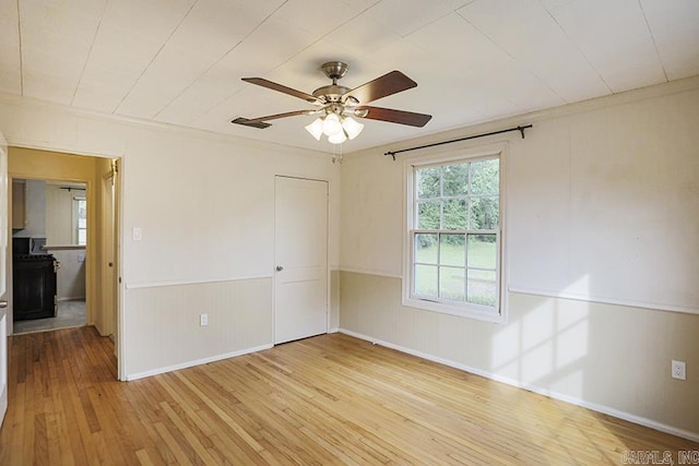 2615 Crouchwood, Little Rock, AR 72207 - unfurnished room with light wood-style floors, a ceiling fan, and wainscoting