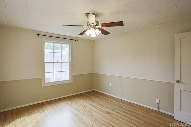 2615 Crouchwood, Little Rock, AR 72207 - spare room featuring wood finished floors, a ceiling fan, ornamental molding, and a wainscoted wall